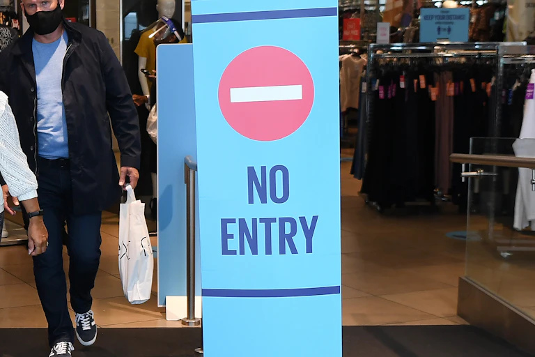 No entry sign in the doorway of a shop using a one-way system.