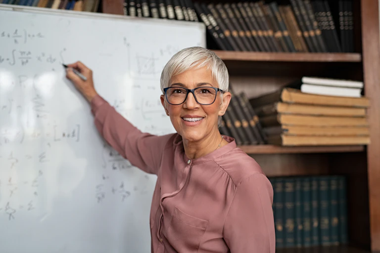 Woman writing on whiteboard