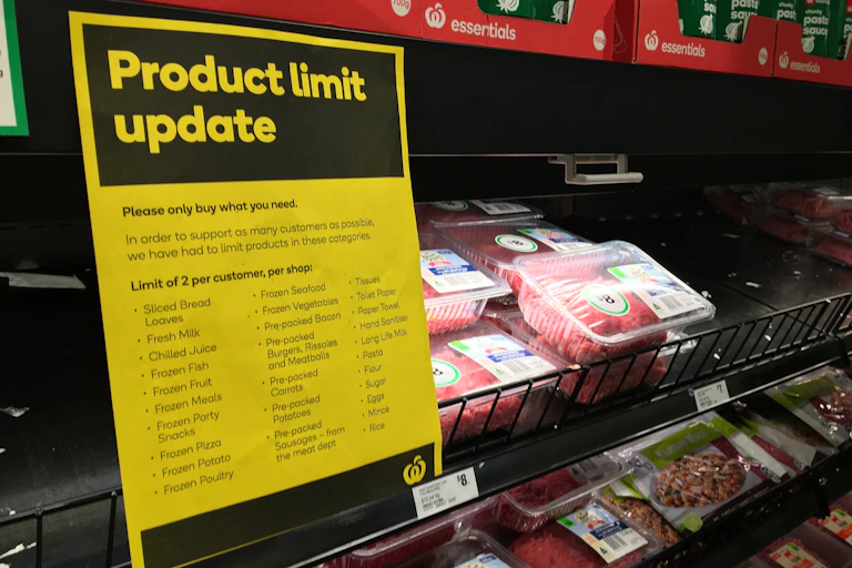 A supermarket meat section, with a sign reading 'Product limit update'