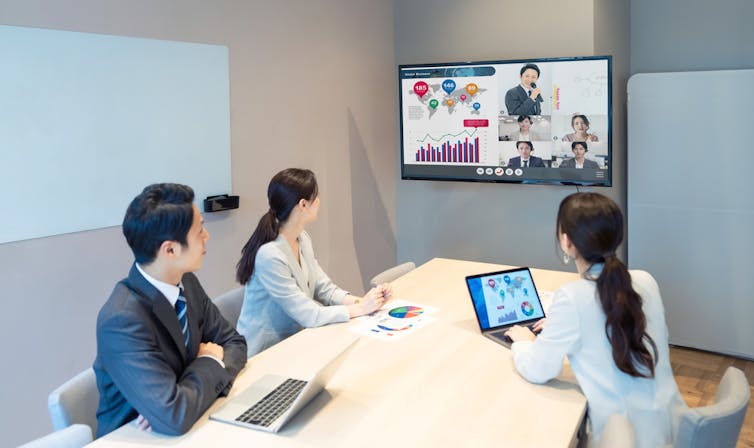 Chinese people having Zoom conference in office