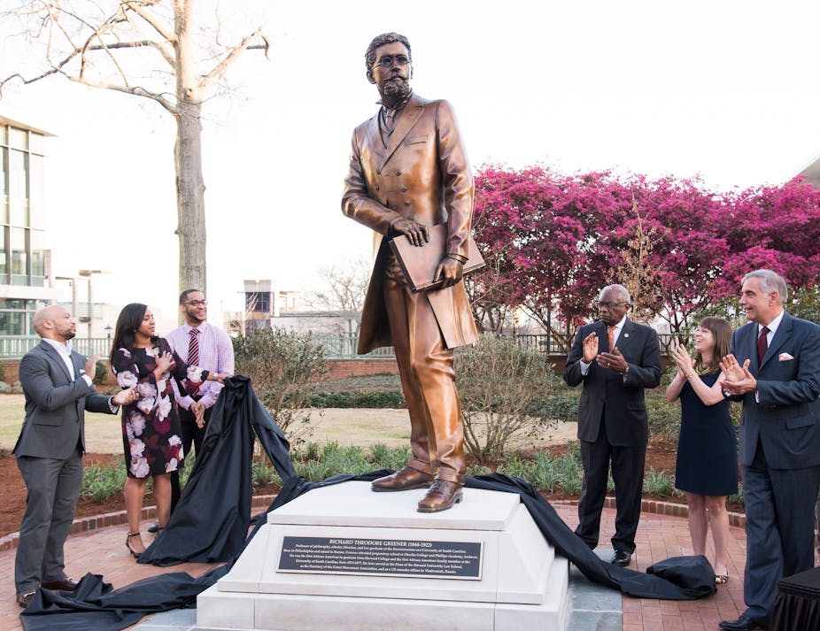 People stand near a statue at the University of South Carolina.