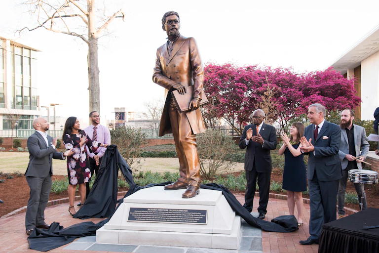 People stand near a statue at the University of South Carolina.