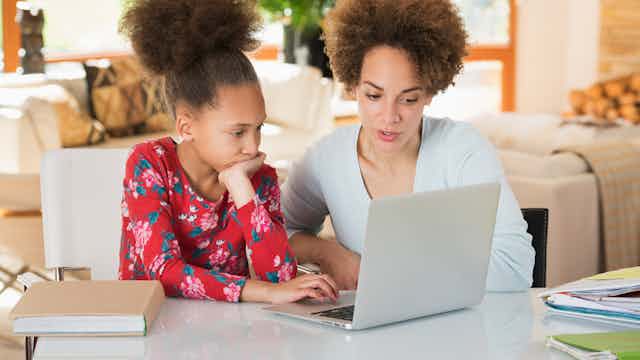 stock photo of mother and daughter looking at a laptop