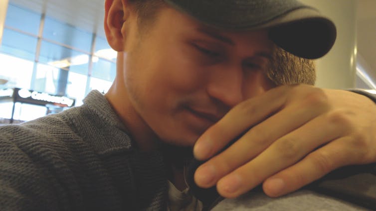 Two men embrace at airport
