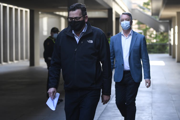 Victorian Premier Daniel Andrews and Mental Health Minister Martin Foley walking and wearing masks