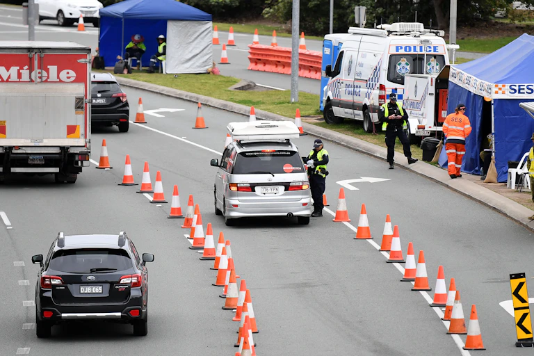 Queensland-NSW border chekpoint, police talking to drivers.