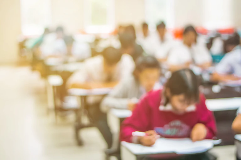 Blurred image of students sitting exam