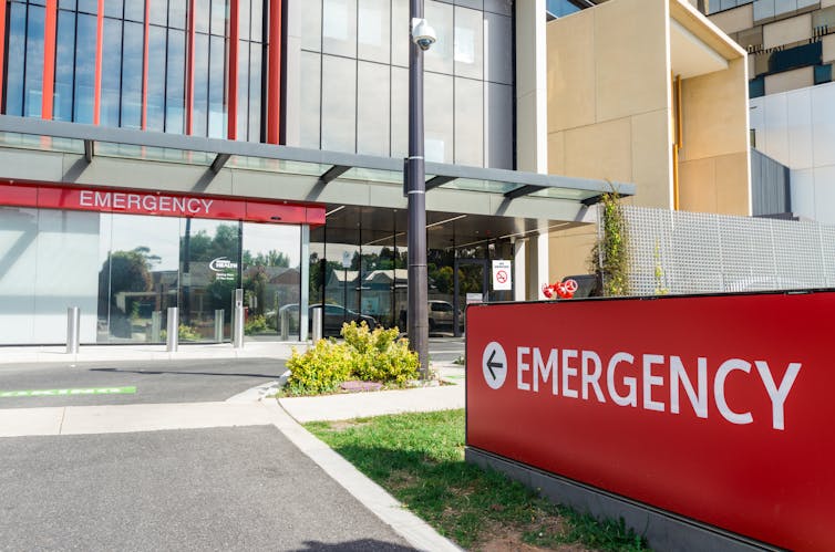 The outside of a hospital with large red 
