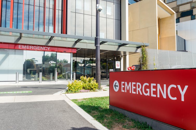 The outside of a hospital with large red