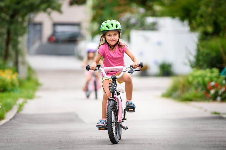 Young girl riding her bike.