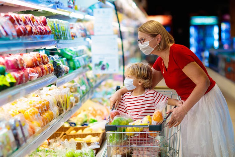 Woman and child in supermarket with trolley