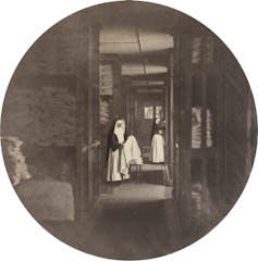 A photograph of two nuns working in a laundry.