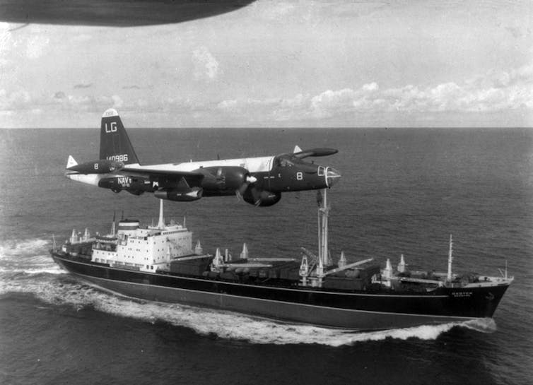 A US aeroplane flying over a Russian boat.