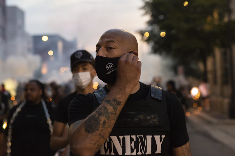 A young Black man in a protest.