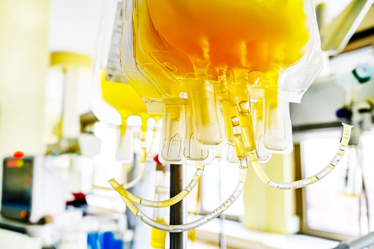 Hanging IV bags of yellow blood plasma
