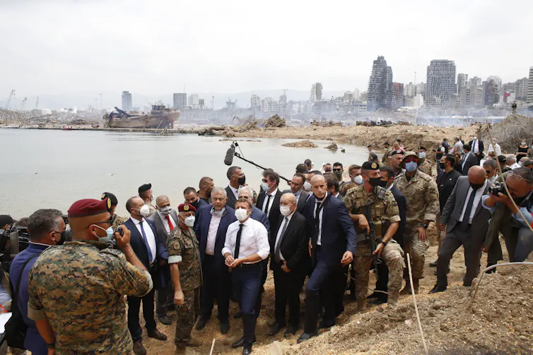 French president Emmanuel Macron in a group of people in Beirut.