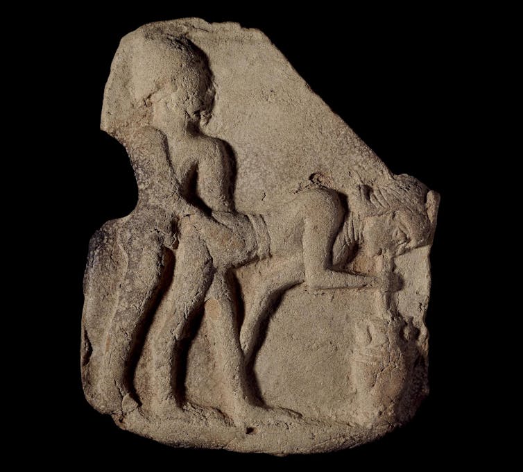 Standing man penetrating a standing woman who is bent over sipping beer out of an urn with a straw