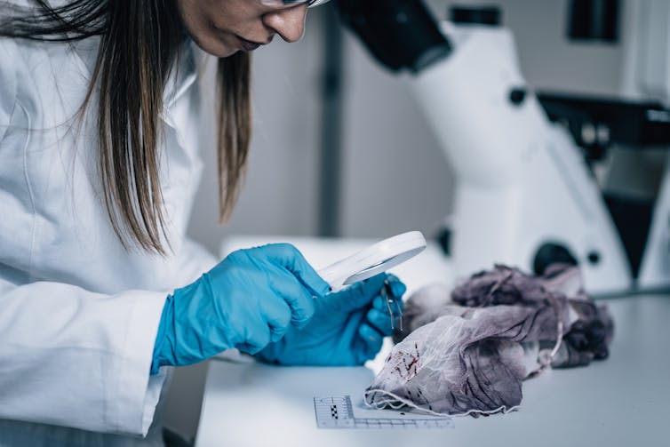 Forensic scientist in lab.