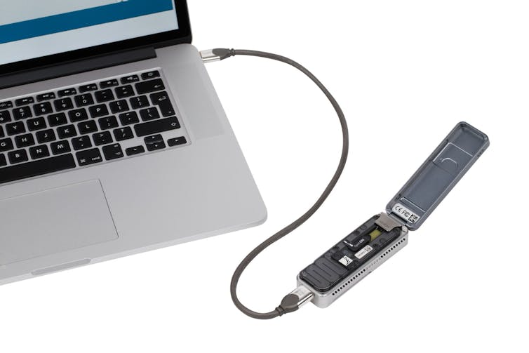 small laboratory device connected to laptop via USB cable