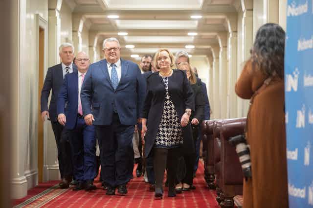 people walking down a corridor at parliament