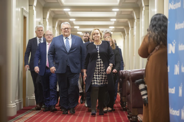 people walking down a corridor at parliament