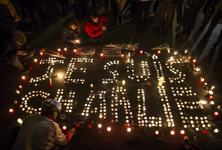 Candelit vigil for victims of the Charlie Hebdo attack, spelling 'Je suis Charlie'.