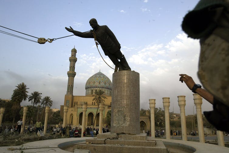 Staute of Saddam Hussein being toppled in 2003.