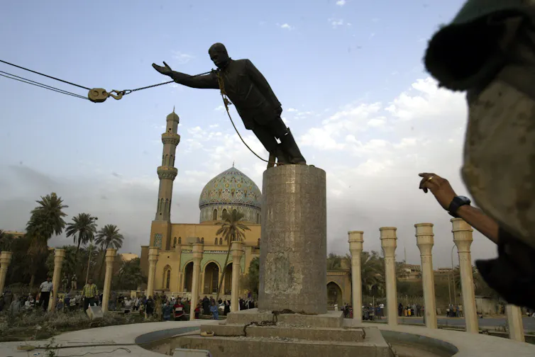 Staute of Saddam Hussein being toppled in 2003.