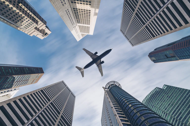 Plane flying over skyscrapers