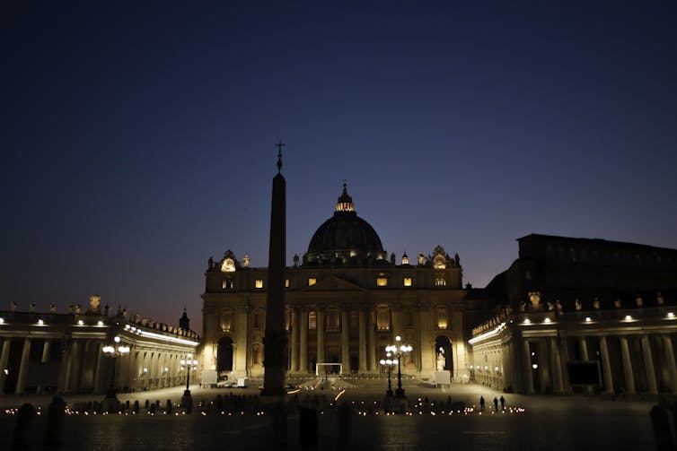 The Vatican is lit up in the darkness.
