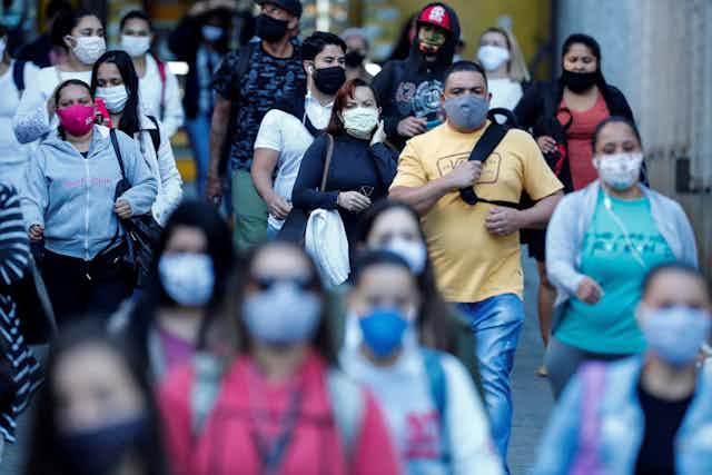 Busy street with people wearing face masks.