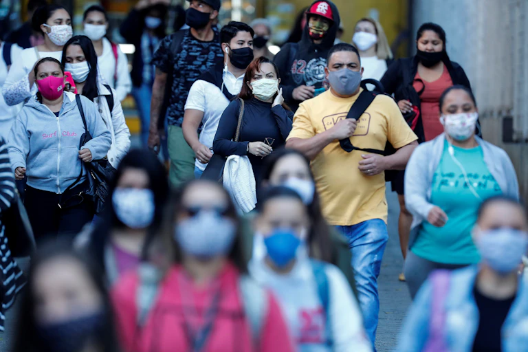 Busy street with people wearing face masks.