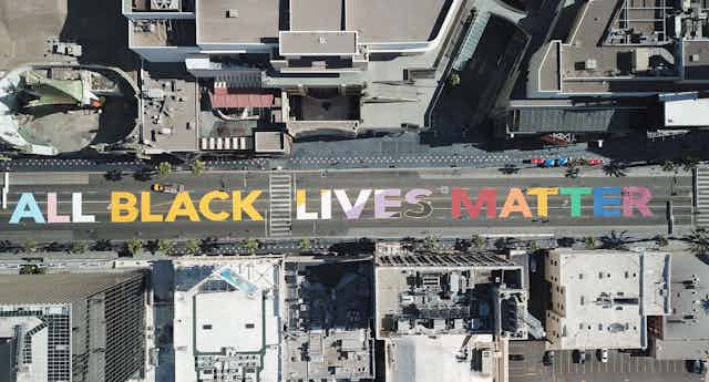 The words "All Black Lives Matter" are seen painted on Hollywood Boulevard in California. 