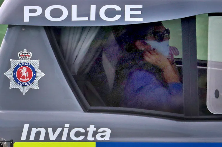 Priti Patel sits in a police boat.