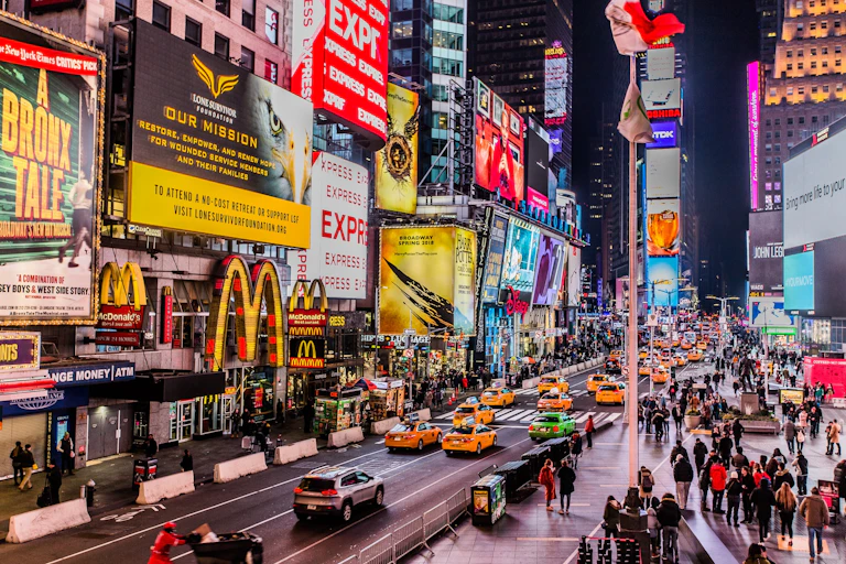 Time Square is lit up with lots of digital billboards.