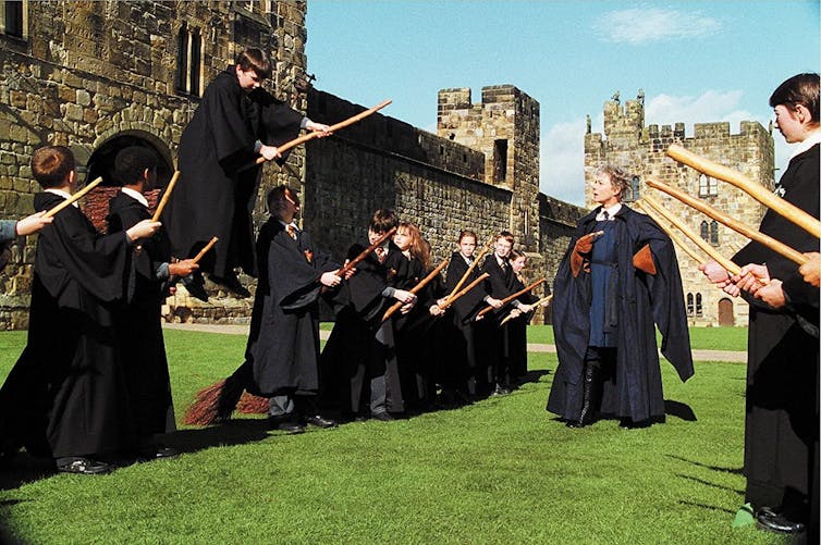 In the Harry Potter movie, young people dressed in black try to ride broomsticks.