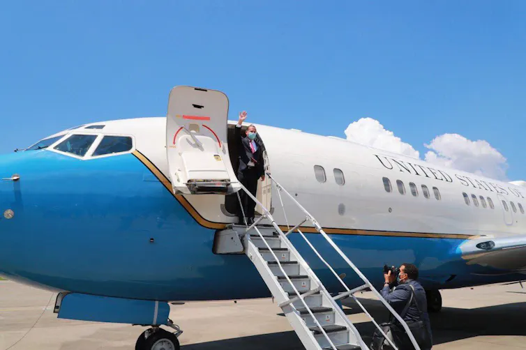 US Health Secretary Alex Azar stepping off plane and waving