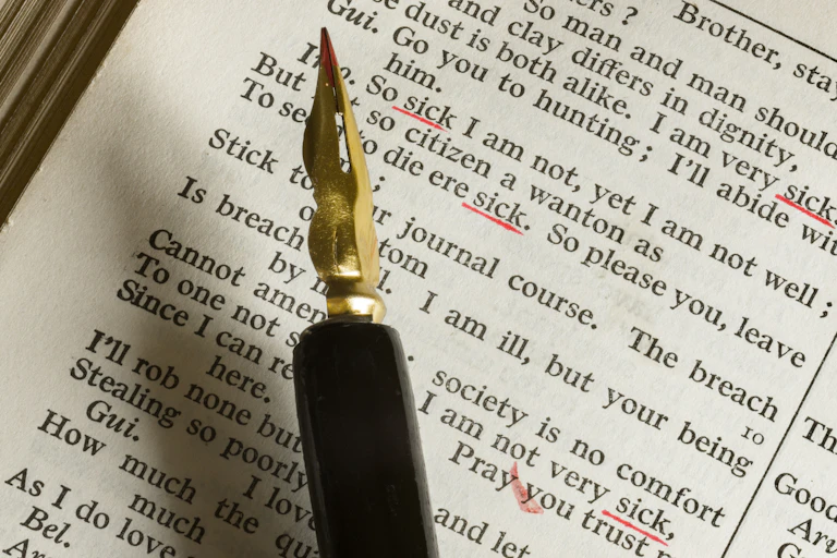 A fountain pen on top of a page of Shakespeare's writing.