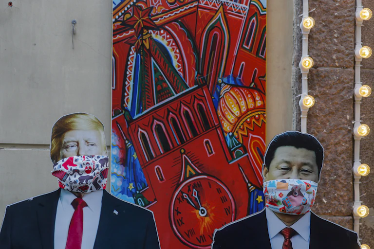 Life-size images of Donald Trump and Xi Jinping with face coverings