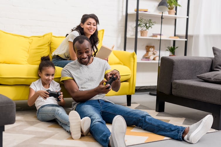 Father and daughter playing a video game