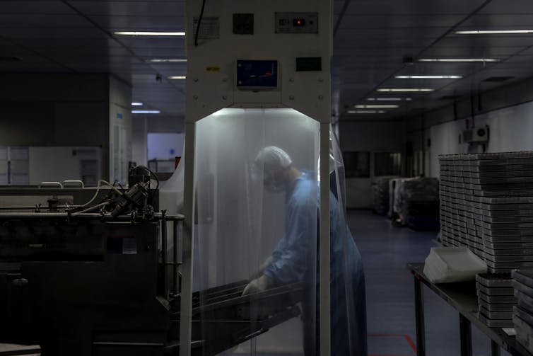 A researcher in a laboratory wearing protective gear