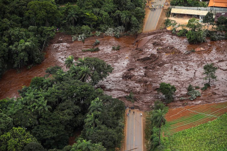 Mud flows over a road in Brazil after a mine accident