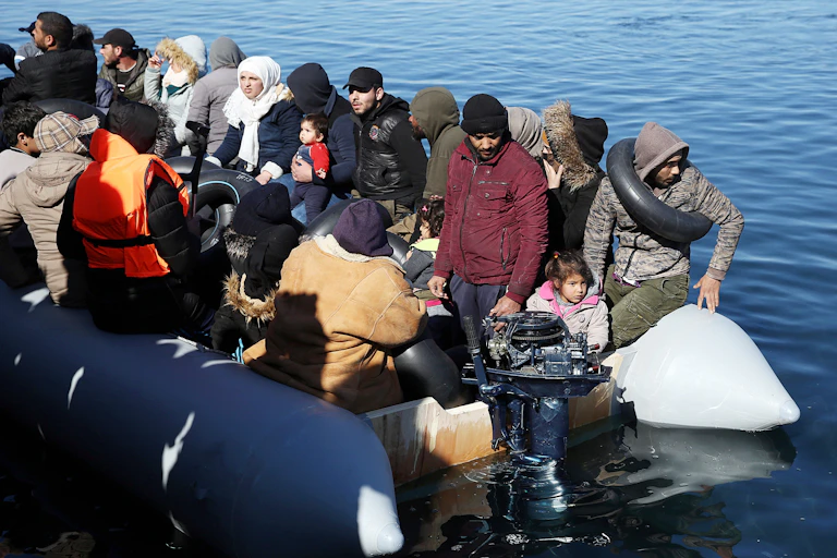 Refugees in an overcrowded dinghy low in the water