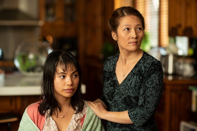 Movie still of two Asian women.