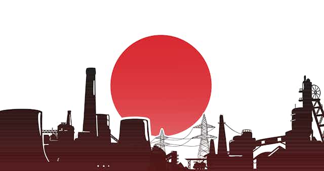 An industrial skyline in front of the Japanese flag