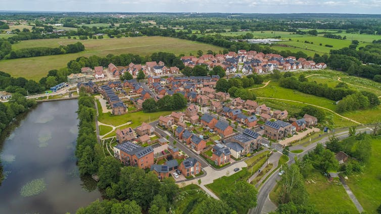 Aerial view of estate of new houses next to river