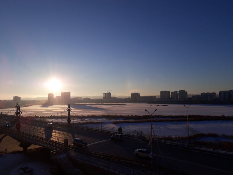 A bridge, buildings and frozen plains.