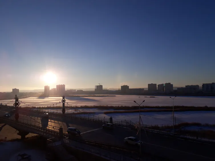 A bridge, buildings and frozen plains.