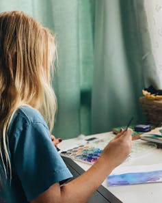 Child painting with brush