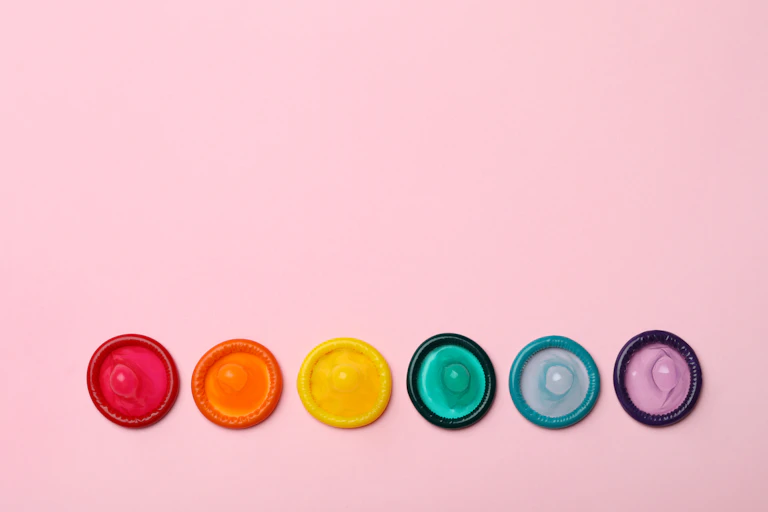 A row of rainbow-coloured condoms